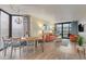 Light and airy open-concept living/dining area featuring balcony access and stylish coastal decor at 2710 N Ocean Blvd. # 402, Myrtle Beach, SC 29577