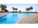 Expansive pool area with plenty of lounge chairs, tropical plants, and a view of the beach at 2710 N Ocean Blvd. # 402, Myrtle Beach, SC 29577