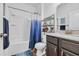 Well-lit bathroom features a white shower-tub, and a vanity with a shower and storage shelves at 2757 Zenith Way, Myrtle Beach, SC 29577