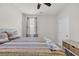 Bedroom featuring a ceiling fan and a window with neutral curtains, plus a comfy quilt and accent pillows at 2757 Zenith Way, Myrtle Beach, SC 29577