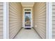 Covered entryway featuring neutral siding and a storm door, offering a welcoming entrance at 2757 Zenith Way, Myrtle Beach, SC 29577
