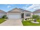 Charming single-story home featuring a well-manicured lawn, attached garage, and neutral siding at 2757 Zenith Way, Myrtle Beach, SC 29577