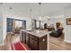 Open-concept kitchen with island seating seamlessly flows into the dining and living areas at 2757 Zenith Way, Myrtle Beach, SC 29577