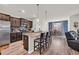 Modern kitchen with stainless steel appliances, a granite island, and dark wood cabinets at 2757 Zenith Way, Myrtle Beach, SC 29577