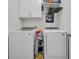 The laundry room has a white washer and dryer with overhead cabinets for easy storage at 2757 Zenith Way, Myrtle Beach, SC 29577
