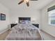 Bright main bedroom with a dark wood bed frame, matching nightstands and a ceiling fan at 2757 Zenith Way, Myrtle Beach, SC 29577