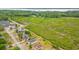 Expansive aerial view of the real estate neighborhood next to grassy landscape with trees and a waterfront area at 2951 Mary Hines Ln., Georgetown, SC 29440