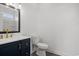 Bathroom with white toilet, sink, and shower, featuring a black faucet and vanity pulls at 2951 Mary Hines Ln., Georgetown, SC 29440