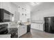 Modern kitchen with white cabinets, stainless steel appliances, and stylish lighting fixtures at 2951 Mary Hines Ln., Georgetown, SC 29440
