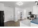 Well-lit kitchen with white cabinetry, black appliances, and durable wood-look flooring at 2951 Mary Hines Ln., Georgetown, SC 29440