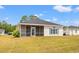 Rear exterior of house with a screened in porch and backyard at 2951 Mary Hines Ln., Georgetown, SC 29440