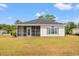 The rear exterior of this home has a screened in porch at 2951 Mary Hines Ln., Georgetown, SC 29440