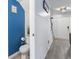 A hallway bathroom featuring blue accent wall with a modern toilet at 3008 Church St. # D3, Myrtle Beach, SC 29577