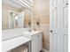 Bright, charming bathroom featuring wood-look walls, a vanity, and a makeup table at 3008 Church St. # D3, Myrtle Beach, SC 29577