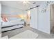 Cozy bedroom featuring a white bunk bed, light blue walls, and a sliding barn door to the bathroom at 3008 Church St. # D3, Myrtle Beach, SC 29577