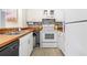 Galley kitchen with white cabinets, wood countertops and a unique backsplash at 3008 Church St. # D3, Myrtle Beach, SC 29577