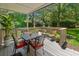 Covered back porch with dining and seating, with a view of the wooded surroundings at 306 Westbury Ct. # 2-B, Myrtle Beach, SC 29572