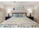 This cozy bedroom features neutral tones, a patterned bedspread, and lamps on either side of the bed at 306 Westbury Ct. # 2-B, Myrtle Beach, SC 29572