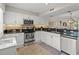 Well-appointed kitchen with white cabinets, granite countertops, and stainless steel appliances at 306 Westbury Ct. # 2-B, Myrtle Beach, SC 29572
