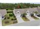 An aerial view highlights the property's landscaping and location in a serene, wooded neighborhood at 3334 Volterra Way # 3334, Myrtle Beach, SC 29579
