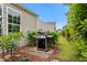 Well-kept grill on brick tile in backyard, bordered by vibrant green foliage at 3334 Volterra Way # 3334, Myrtle Beach, SC 29579
