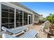 Backyard patio with outdoor seating, a screened-in porch, and landscaped surroundings at 3334 Volterra Way # 3334, Myrtle Beach, SC 29579