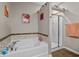 Relaxing bathroom featuring a separate shower and jetted tub, with decorative tile accent at 3334 Volterra Way # 3334, Myrtle Beach, SC 29579