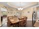Formal dining room featuring wood flooring, chandelier lighting, and an open layout connecting to other living spaces at 3334 Volterra Way # 3334, Myrtle Beach, SC 29579