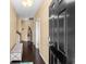 Inviting entryway with dark wood floors, a comfortable bench, and a staircase leading to the upper level at 3334 Volterra Way # 3334, Myrtle Beach, SC 29579
