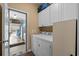 Well-equipped laundry room with modern washer, dryer and ample cabinet space at 3334 Volterra Way # 3334, Myrtle Beach, SC 29579