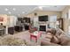 Cozy living room featuring an open concept layout with vaulted ceiling, fireplace, and seamless kitchen access at 3334 Volterra Way # 3334, Myrtle Beach, SC 29579