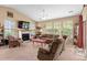 Inviting living room with a fireplace, large windows, comfortable seating, and a cozy atmosphere at 3334 Volterra Way # 3334, Myrtle Beach, SC 29579
