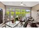 Inviting sunroom with ample seating, a ceiling fan, and serene views of the surrounding landscape at 3334 Volterra Way # 3334, Myrtle Beach, SC 29579