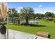 Relaxing backyard view with a serene pond, mature palm trees, and beautifully maintained landscaping at 347 Kessinger Dr., Surfside Beach, SC 29575