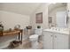Cozy bathroom featuring a toilet, sink, a mirror, and a small table with decorations at 347 Kessinger Dr., Surfside Beach, SC 29575