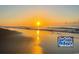 Picturesque beach scene with golden sand and a vibrant sunrise, creating a serene coastal atmosphere at 347 Kessinger Dr., Surfside Beach, SC 29575