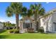 Charming home exterior featuring a brick facade, lush lawn, and decorative palm trees at 347 Kessinger Dr., Surfside Beach, SC 29575