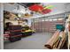 Spacious garage with ample storage, featuring overhead racks, shelving, and a clean, carpeted floor at 347 Kessinger Dr., Surfside Beach, SC 29575