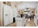Kitchen with white cabinets and a refrigerator next to an island that opens into a dining area at 347 Kessinger Dr., Surfside Beach, SC 29575