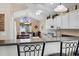 Open kitchen with a breakfast bar, white cabinets, and adjacent dining area at 347 Kessinger Dr., Surfside Beach, SC 29575