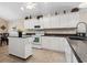 Traditional kitchen with white cabinets, dark countertops, and a kitchen island on a tiled floor at 347 Kessinger Dr., Surfside Beach, SC 29575
