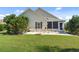 Back patio with outdoor seating, a well-maintained lawn, and mature trees at 347 Kessinger Dr., Surfside Beach, SC 29575