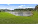 Lush backyard with a scenic pond, green grass, and waterfront views at 347 Kessinger Dr., Surfside Beach, SC 29575