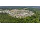 Aerial view showcases a community with winding roads, a pond, and lush green spaces at 362 Shallow Cove Dr., Conway, SC 29527