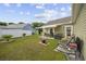 Backyard featuring patio with seating and retractable awning, well maintained lawn, and pond views at 362 Shallow Cove Dr., Conway, SC 29527