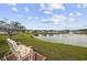 Relaxing backyard view features a lake, fountain, and comfortable seating area on a brick patio at 362 Shallow Cove Dr., Conway, SC 29527