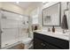 Modern bathroom featuring a tiled walk-in shower, vanity with storage, and a well-lit mirror at 362 Shallow Cove Dr., Conway, SC 29527