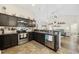 Well-equipped kitchen with stainless steel appliances, dark cabinetry, and an open view to the living area at 362 Shallow Cove Dr., Conway, SC 29527