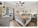 Bedroom with a decorative headboard, ceiling fan, bedside table and dresser, and wood-look flooring at 362 Shallow Cove Dr., Conway, SC 29527