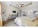 Bright main bedroom with tray ceiling, neutral tones, and a ceiling fan at 362 Shallow Cove Dr., Conway, SC 29527